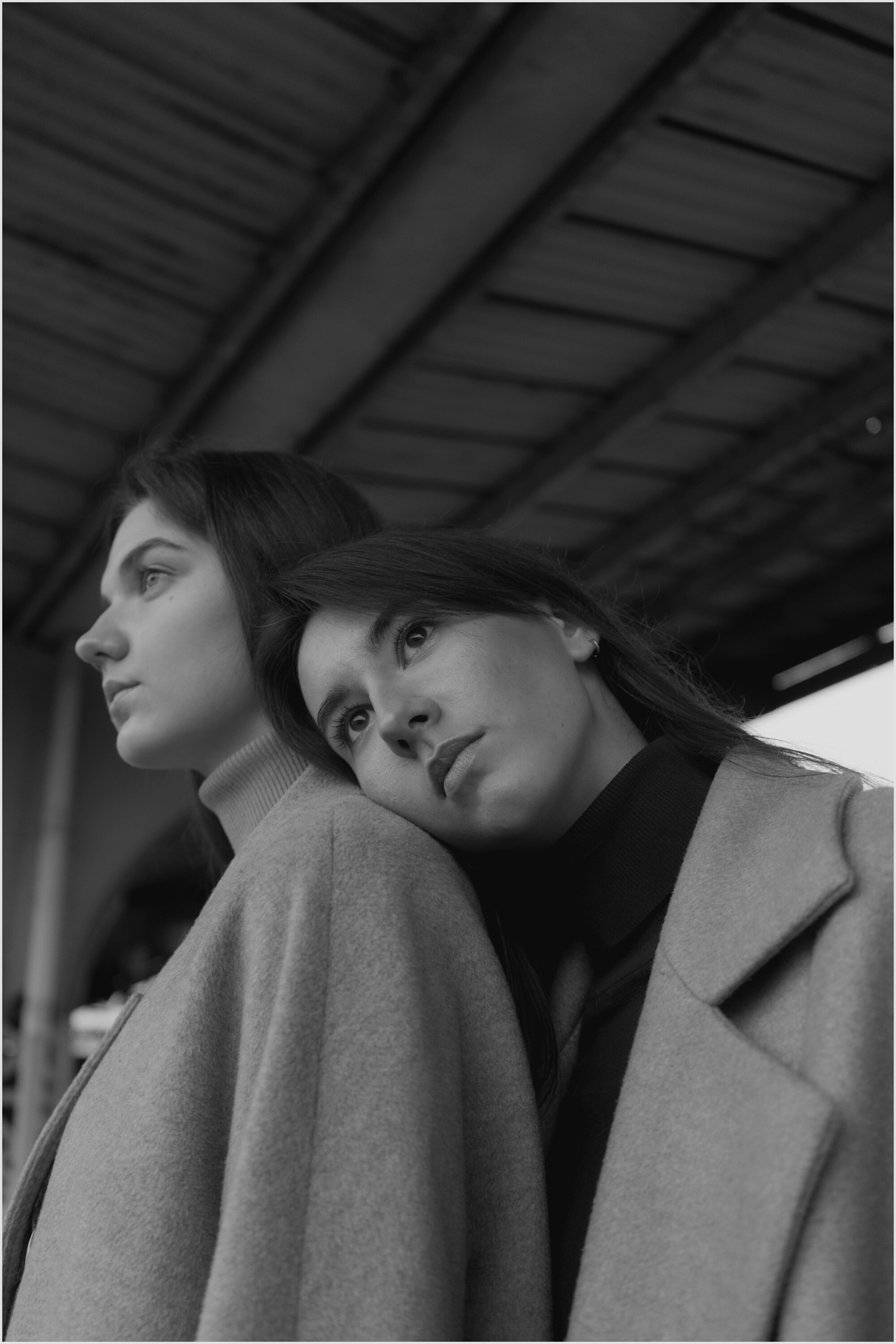 Fashionable couple standing close on railway station